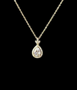 18K gold-plated, crystal teardrop pendant, sleek chain, timeless elegance, versatile, on a black background.